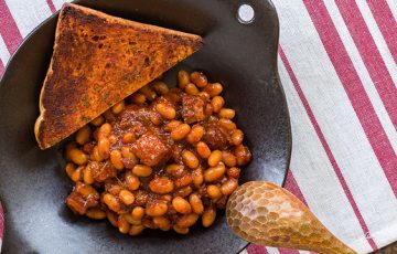The Kimchi Baked Beans are the perfect blend of sweet and savory, a Korean twist on a classic dish.