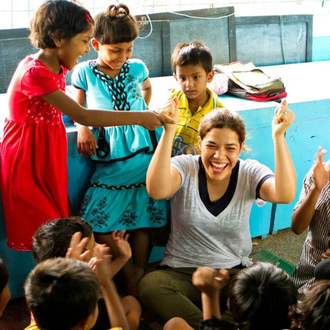 Woman playing with group of children