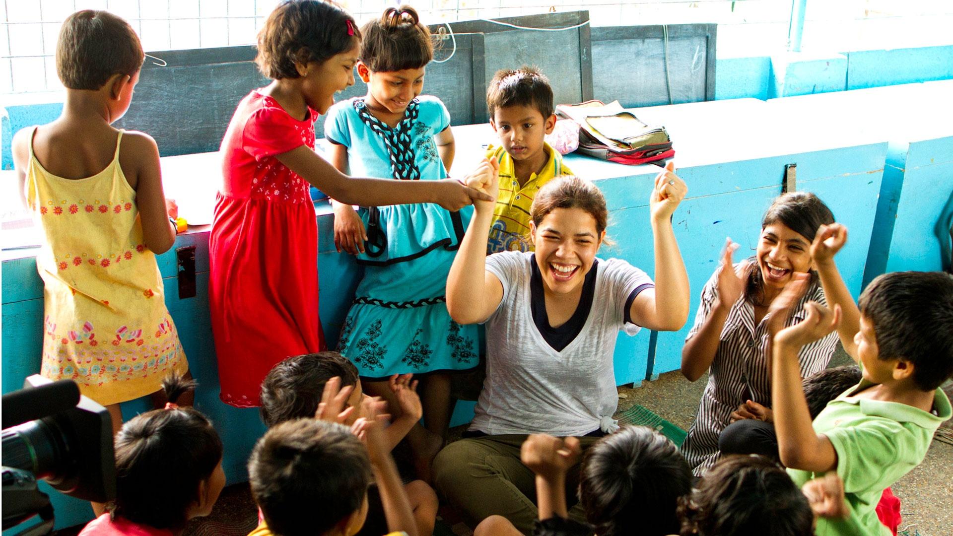 Woman playing with group of children