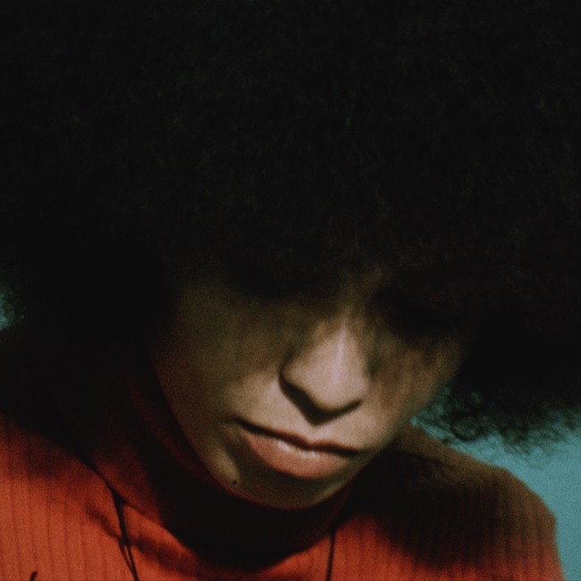 Angela Davis looking down eyes covered by hair