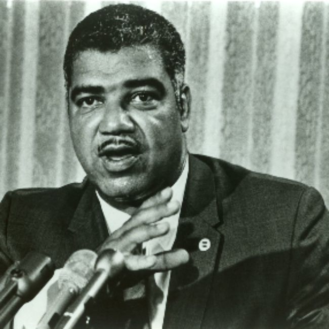 Black and white closeup shot of Whitney Young Jr. at microphone