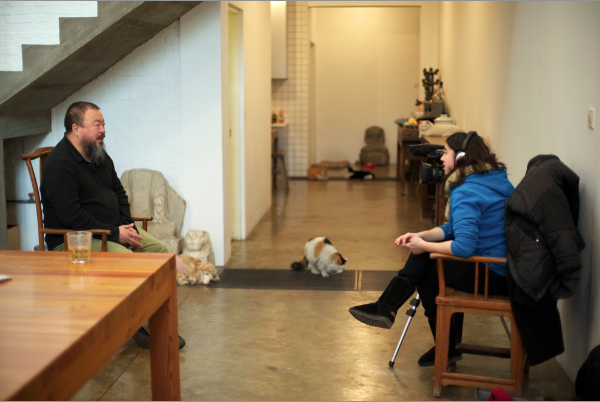 Wide shot of Ai Weiwei being interviewed by Alison Klayman at his studio