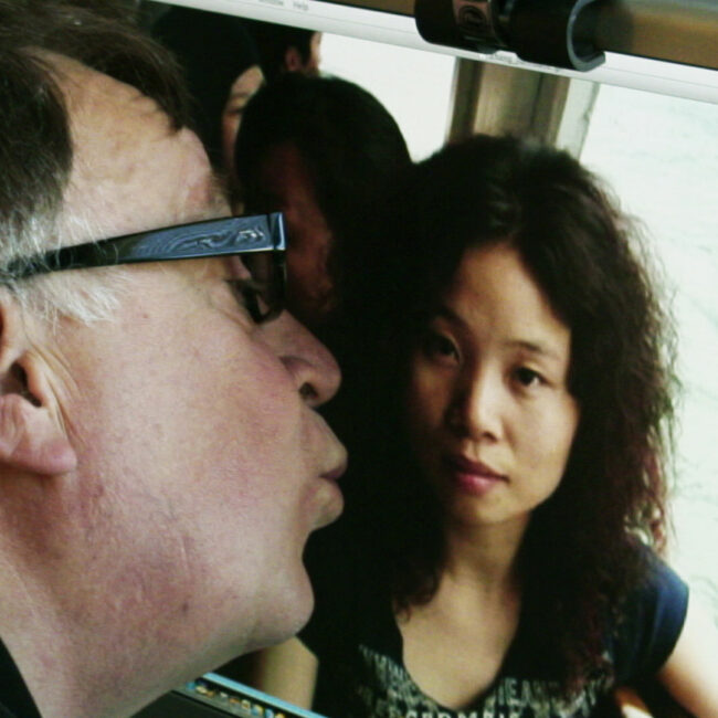 Steven of kissing photo of Asian woman on computer screen.