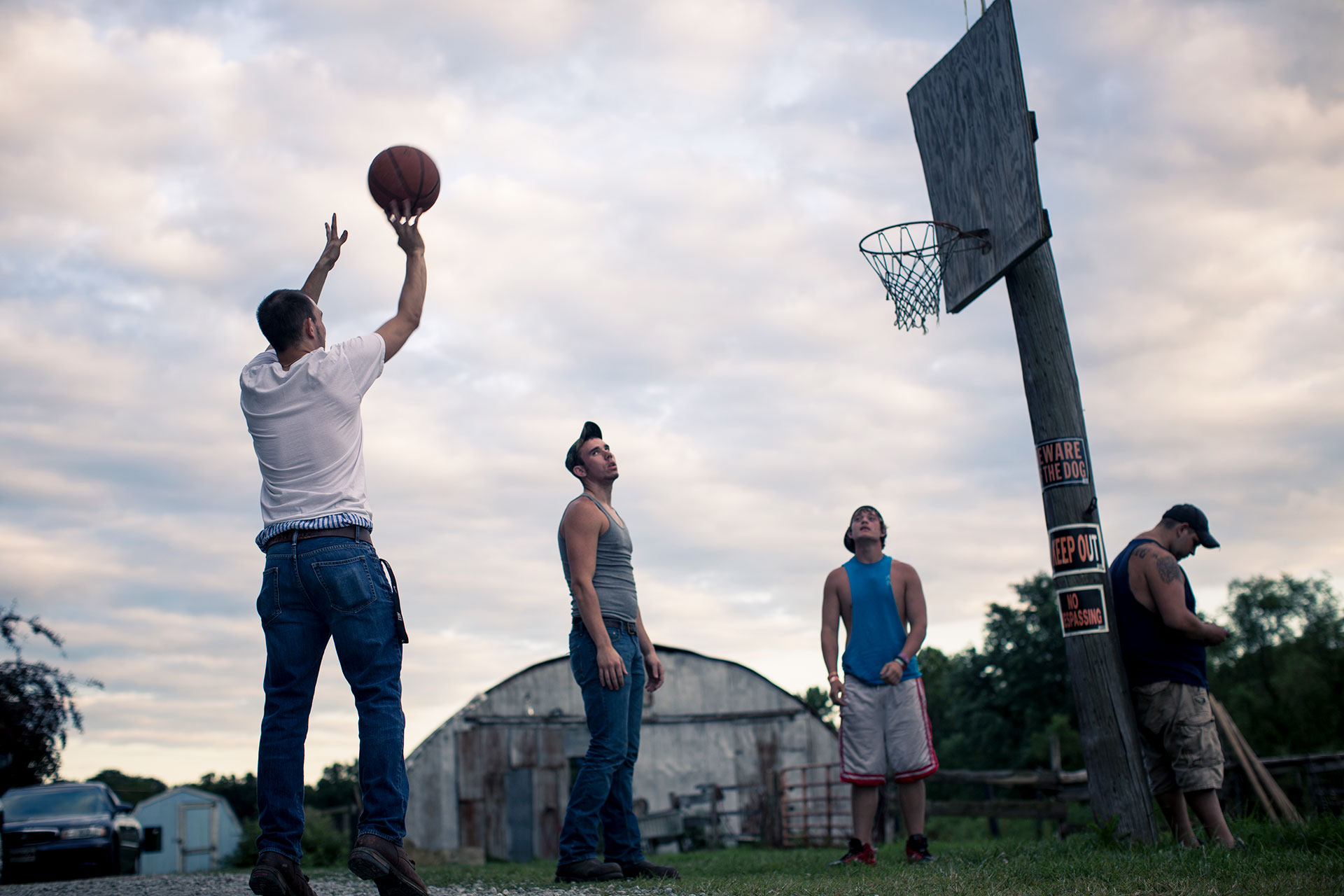 Kids of Medora shooting basketball outside in their street clothes