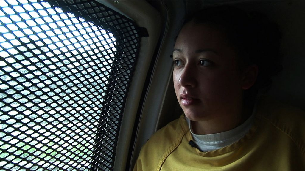 Cyntoia Brown gazes out a prison van window.