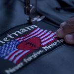 Biker patch featuring a broken heart on an American flag and the words, "Vietnam: Never Forgive, Never Forget."