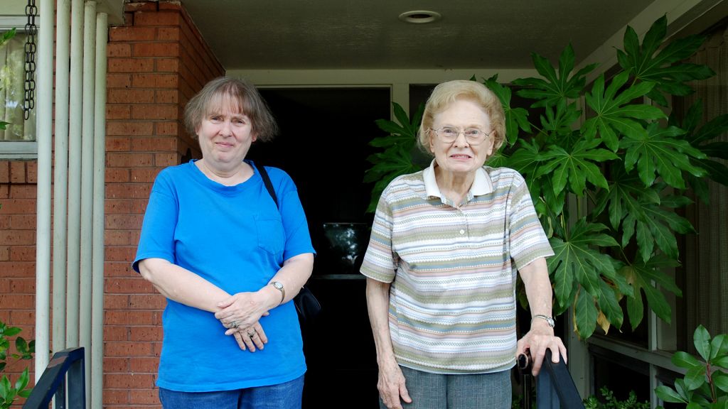 Dona and her mother Mimi stand on their suburban Dallas porch