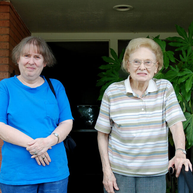 Dona and her mother Mimi stand on their suburban Dallas porch