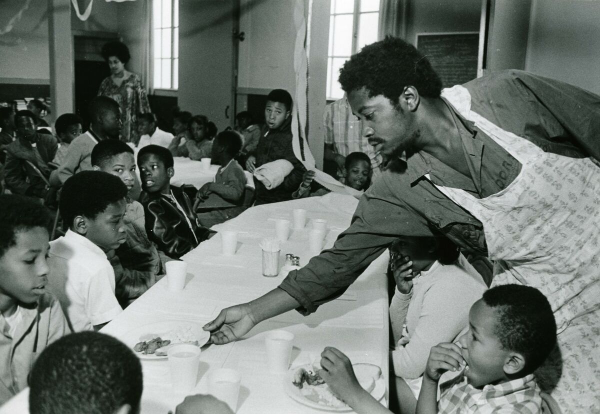 man serving many children at Black Panther breakfast program