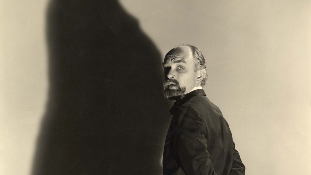 James "The Amazing" Randi stands casting large shadow against wall