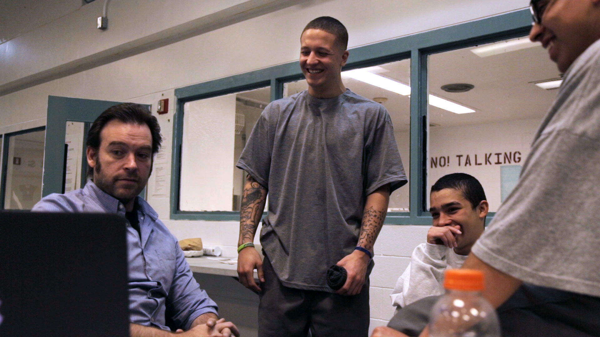 L-R: Gabe Cowan (teacher/producer), Jarad, Antonio, Juan all look at footage from their film