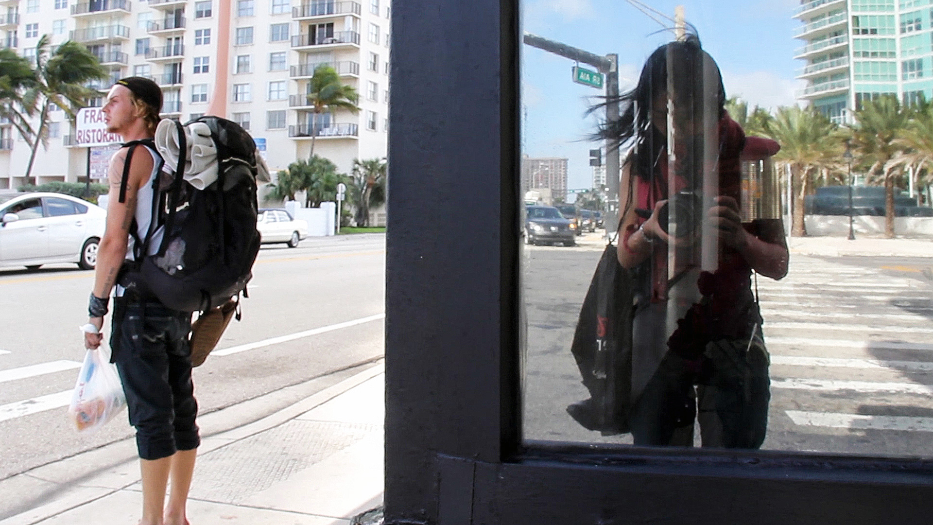 Dylan with filmmaker Nanfu Wang reflected at right, shooting I Am Another You