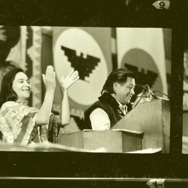 Dolores Huerta, with Cesar Chavez, in public speech from the 60s, in a film strip image