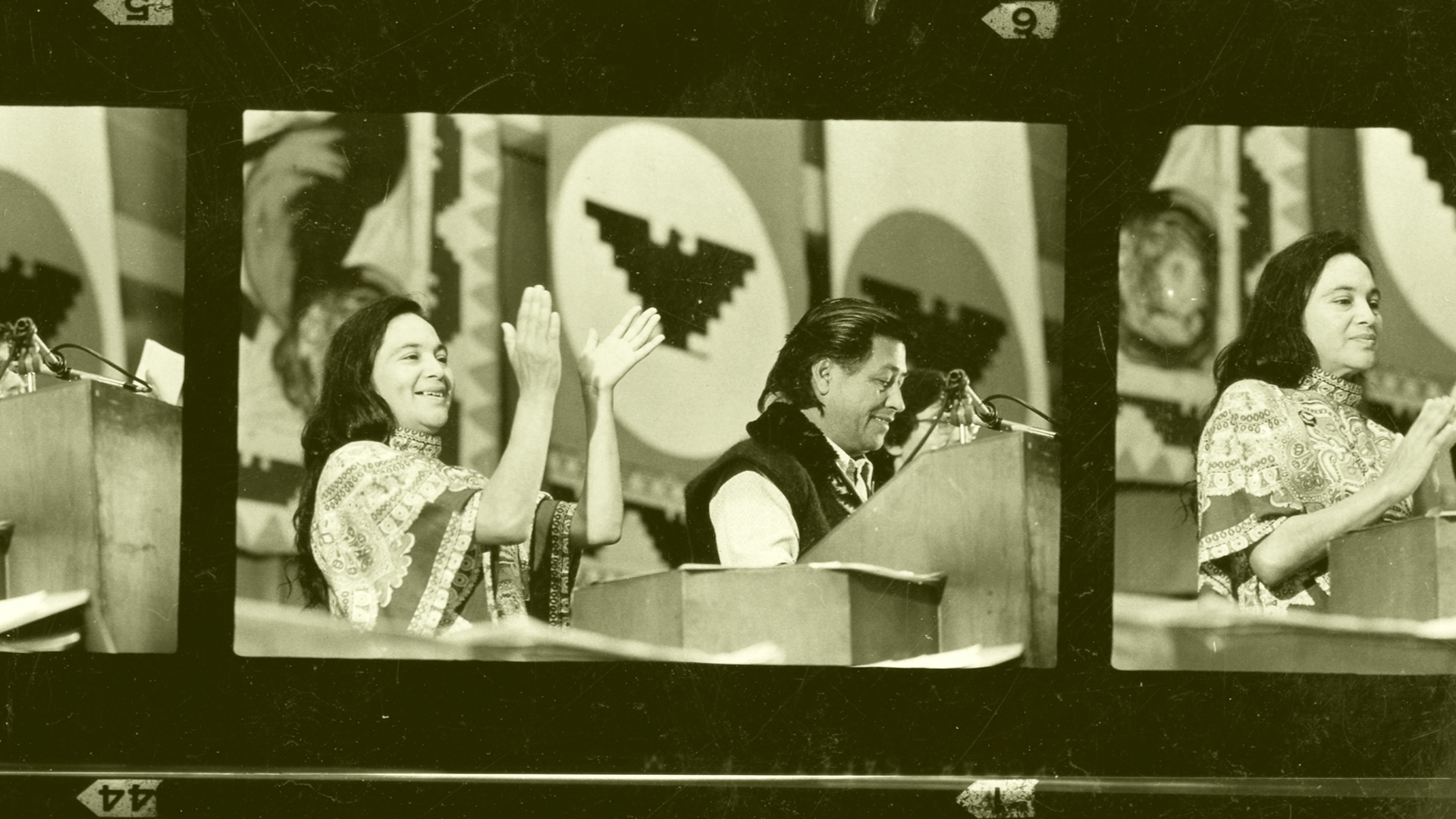 Dolores Huerta, with Cesar Chavez, in public speech from the 60s, in a film strip image