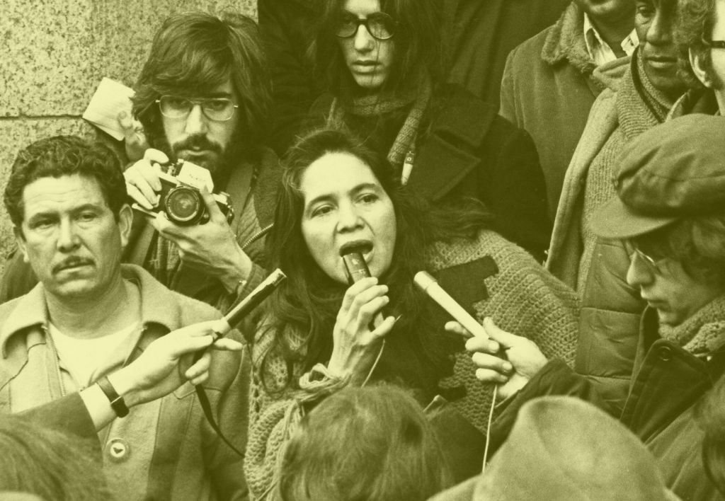 Dolores Huerta at a press conference, as seen in the movie Dolores