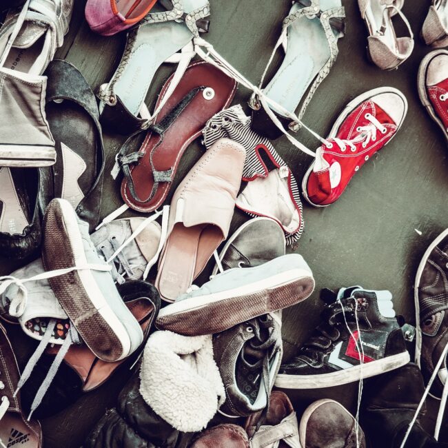 a big pile of worn sneakers, free image courtesy of Pixabay