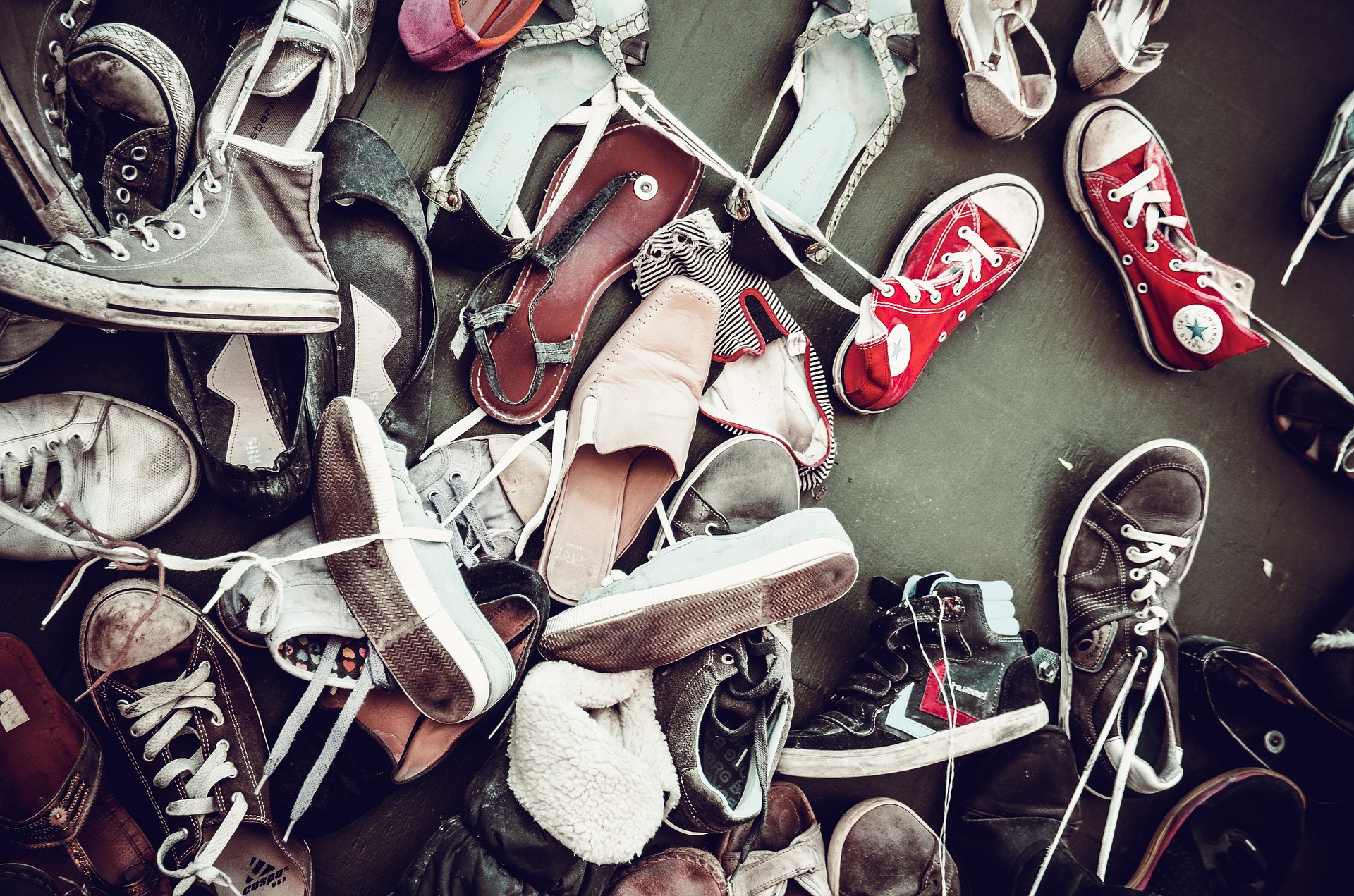 a big pile of worn sneakers, free image courtesy of Pixabay