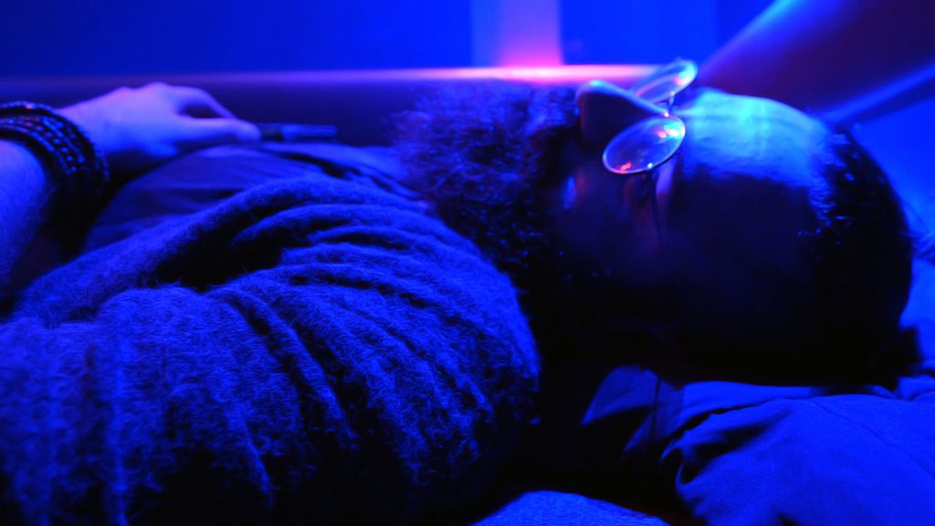 Shahin Najafi resting before concert, in ultraviolet light