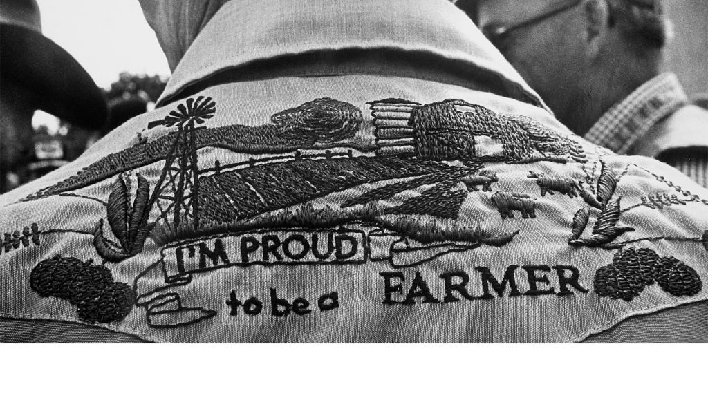 Proud to be a farmer emblem on back of farmer's shirt, in Look and See