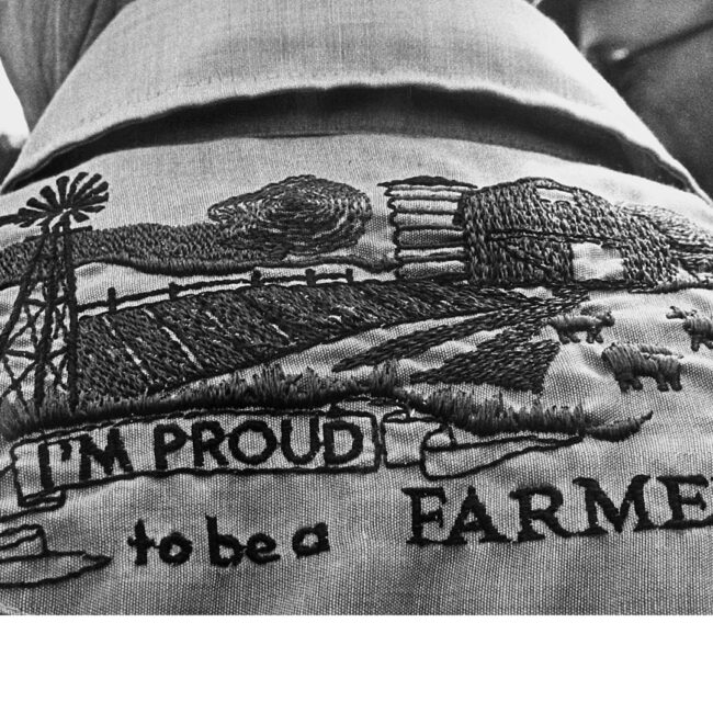 Proud to be a farmer emblem on back of farmer's shirt, in Look and See