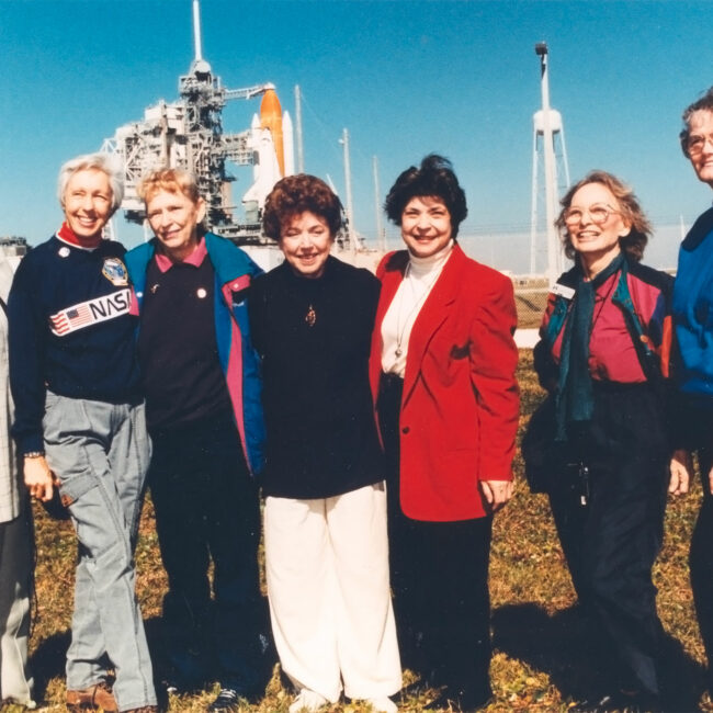 At the Kennedy Space Center, seven women who once aspired to fly into space stand outside Launch Pad 39B neat the Space Shuttle Discovery, poised for liftoff on the first flight of 1995. They are members of the First Lady Astronaut Trainees (FLATs, also known as the 