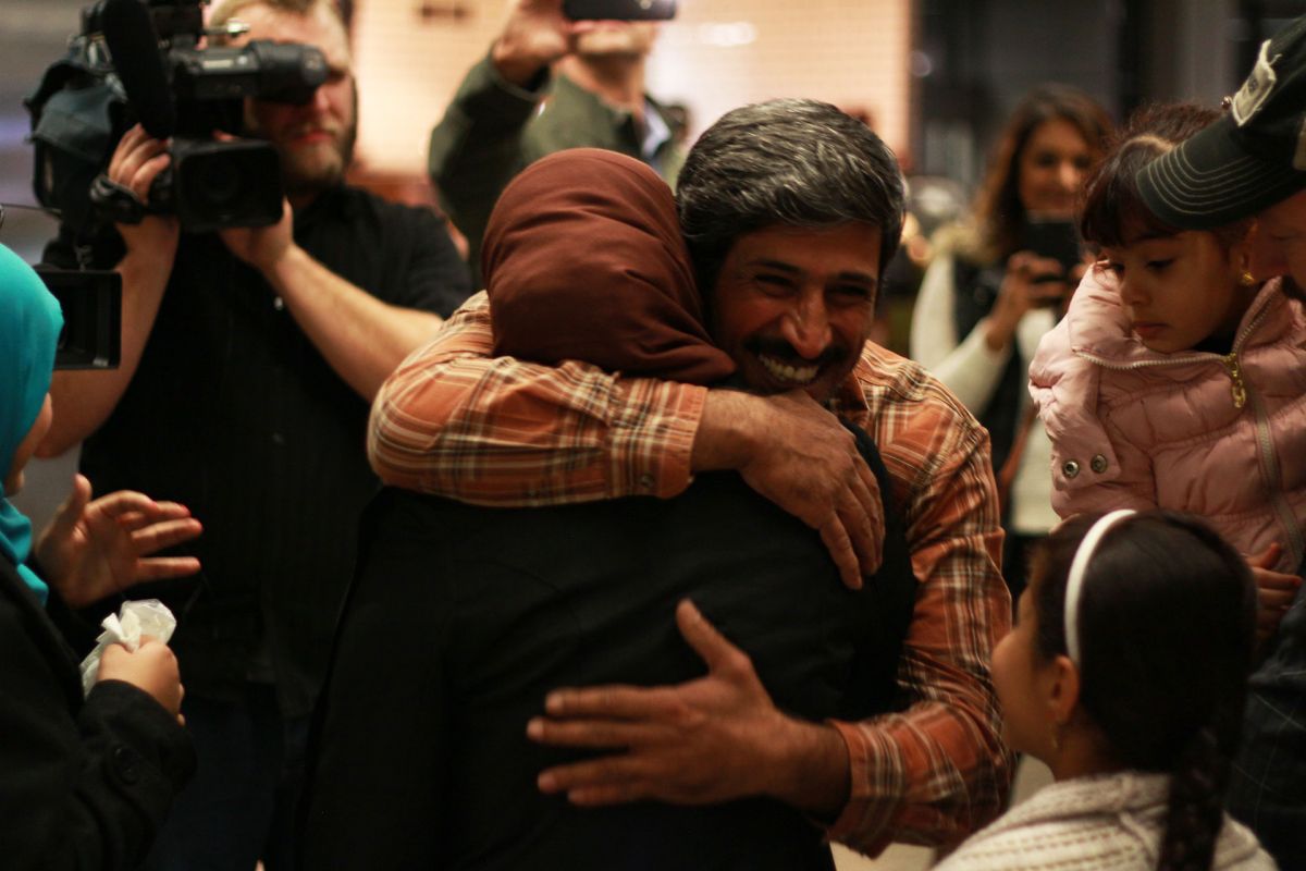 Phillip Morris hugs his wife when reunited at Minneapolis airport.