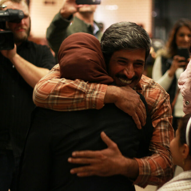 Phillip Morris hugs his wife when reunited at Minneapolis airport.