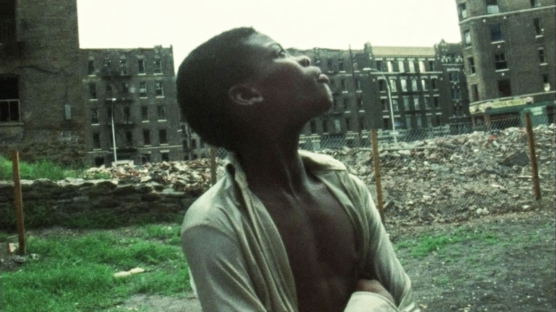 An African American boy looks up at burned out buildings in the Bronx, circa late 70s