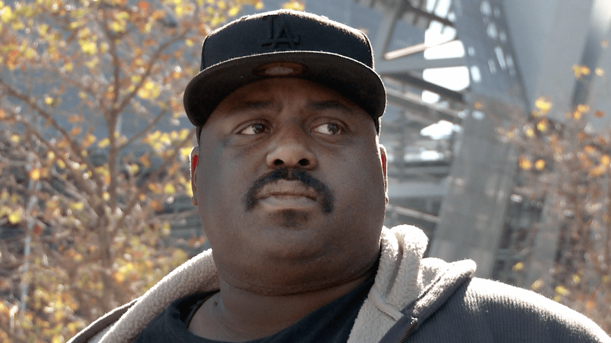 African American man wearing LA hat with worried face