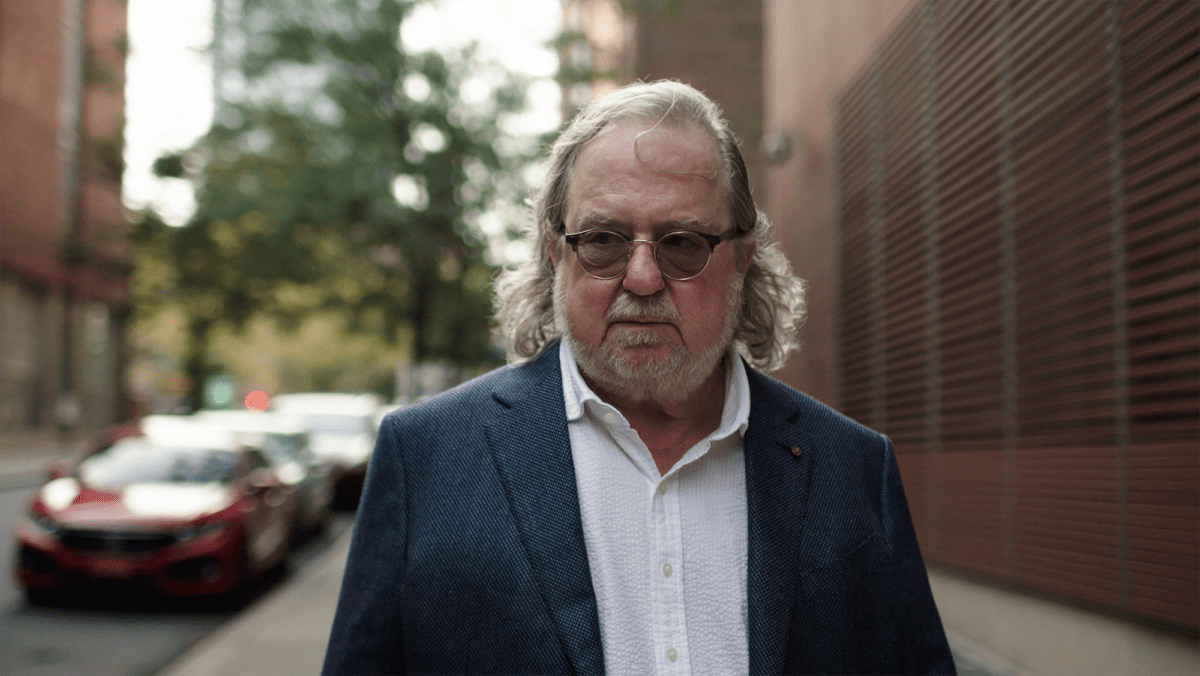 Jim Allison walking on a street