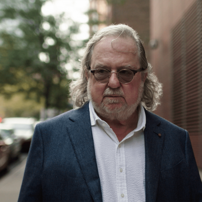 Jim Allison walking on a street