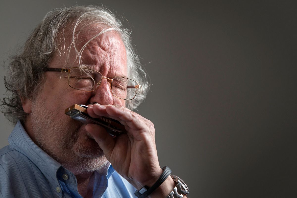 Cancer researcher Jim Allison playing his blues harmonica