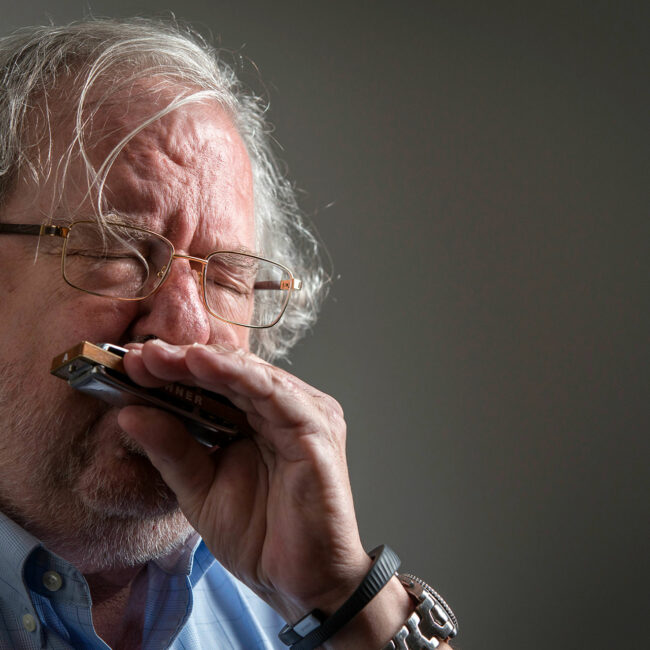 Cancer researcher Jim Allison playing his blues harmonica