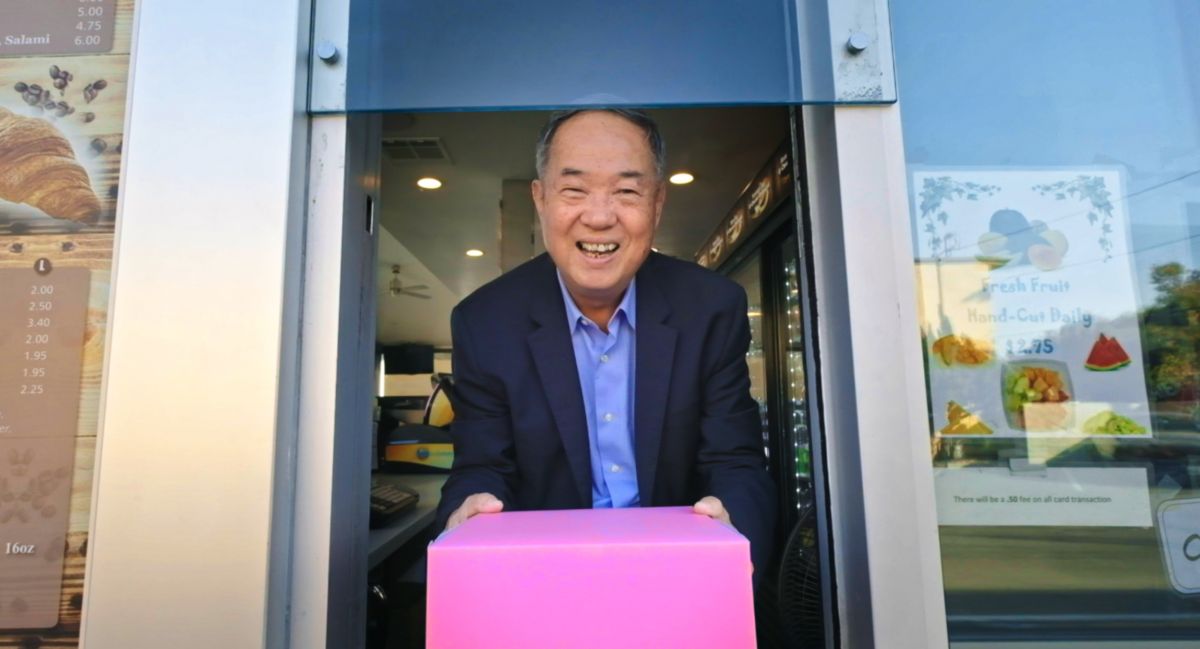 Ted Ngoy holds his famous pink pastry box, in The Donut King