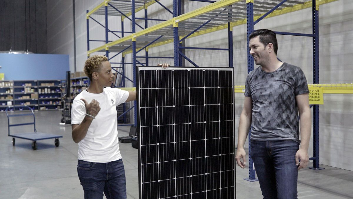 Jonathan Scott at a solar company in Nevada, with solar panel