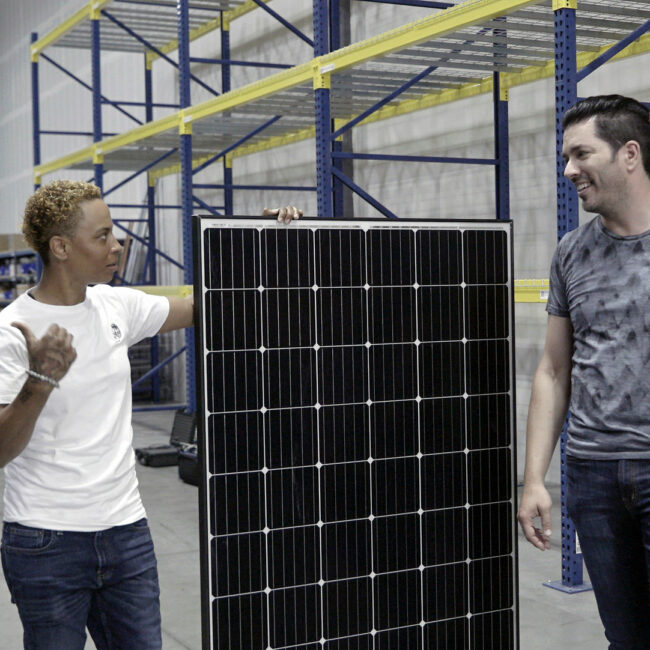 Jonathan Scott at a solar company in Nevada, with solar panel