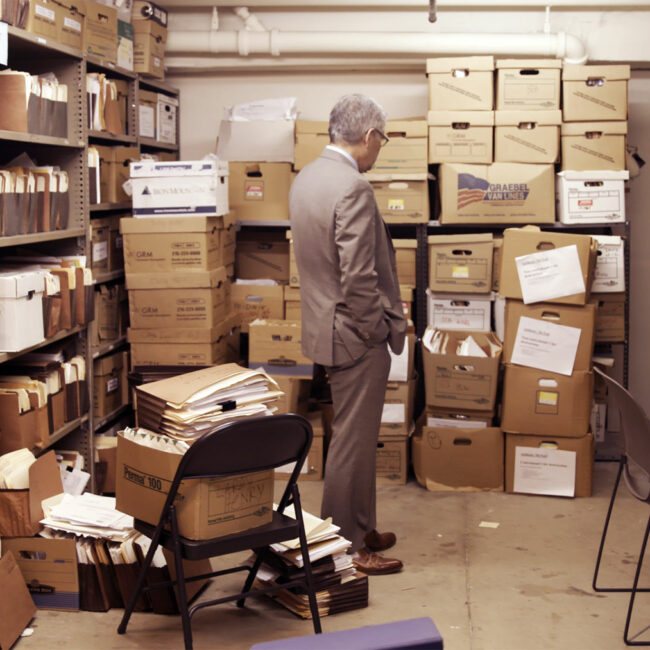 Larry Krasner looks over a ton of file boxes from way back, in Philly D.A.