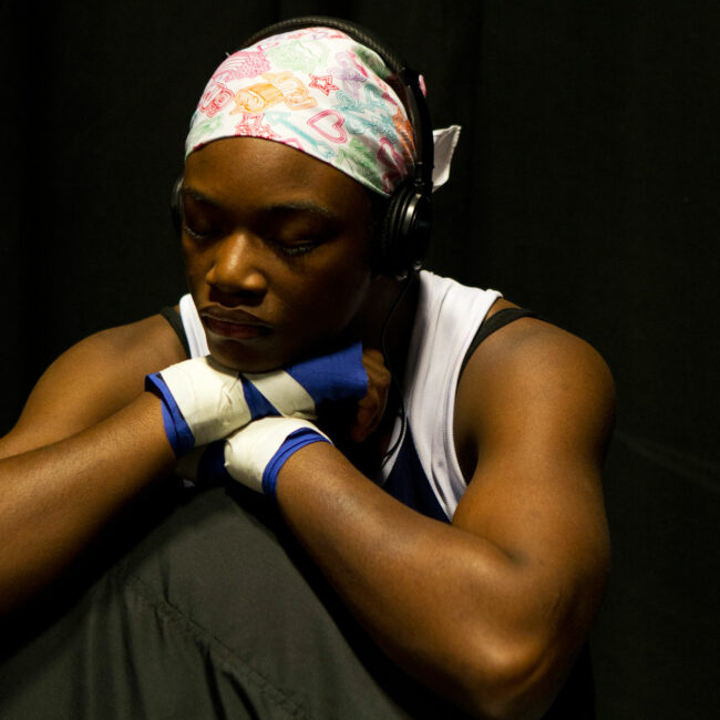 Claressa Shields deep in thought while listening to music with headphones
