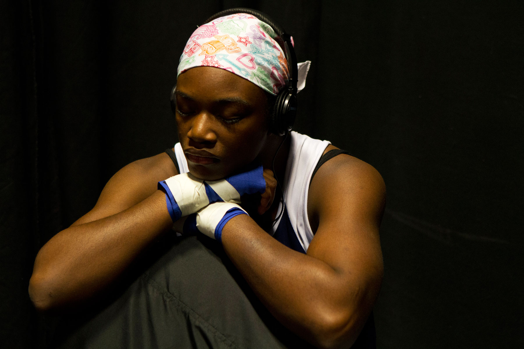 Claressa Shields deep in thought while listening to music with headphones