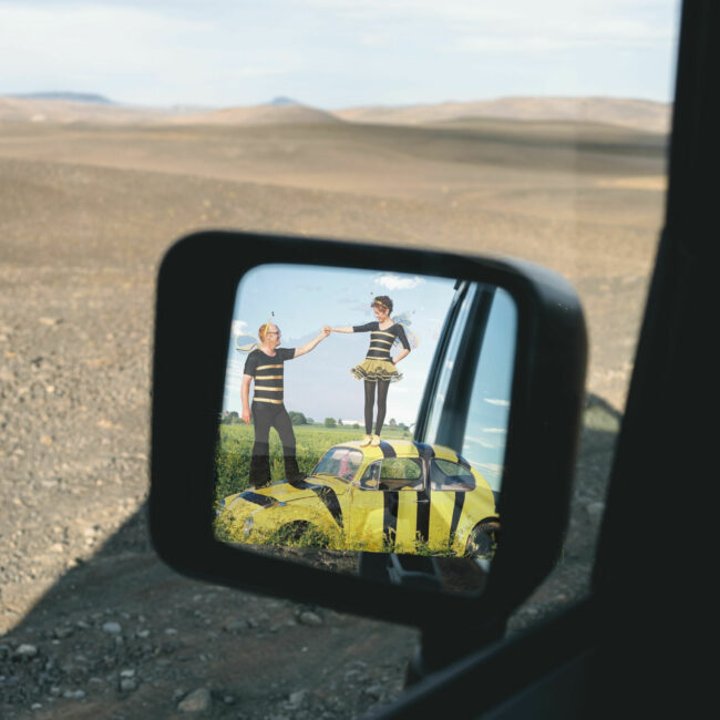 Side mirror with image from Real Dirt on Farmer John in the mirror
