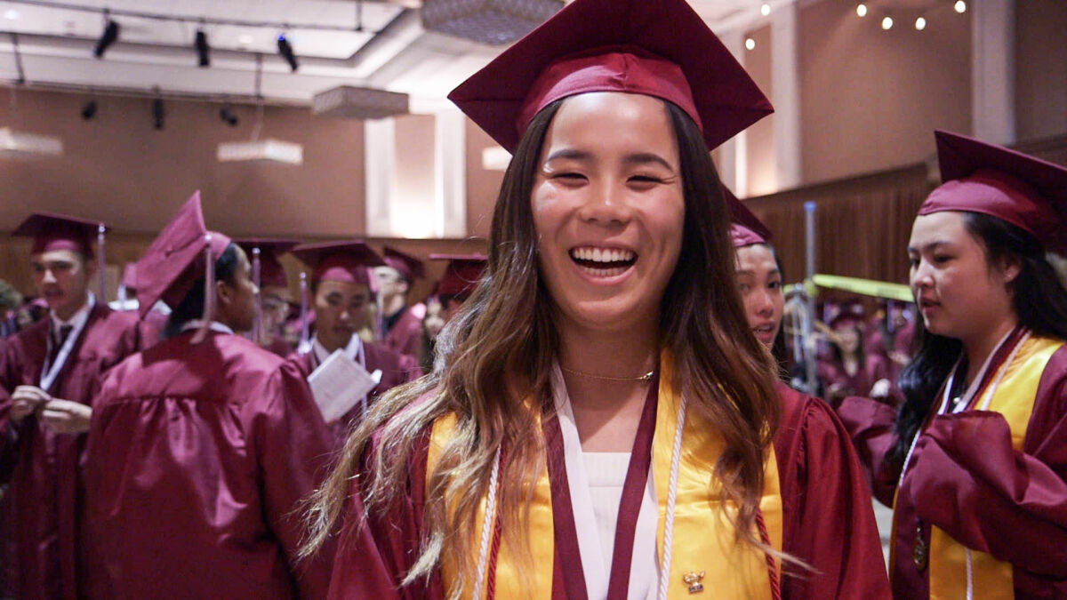 Sophia at Graduation, happy in cap and gown