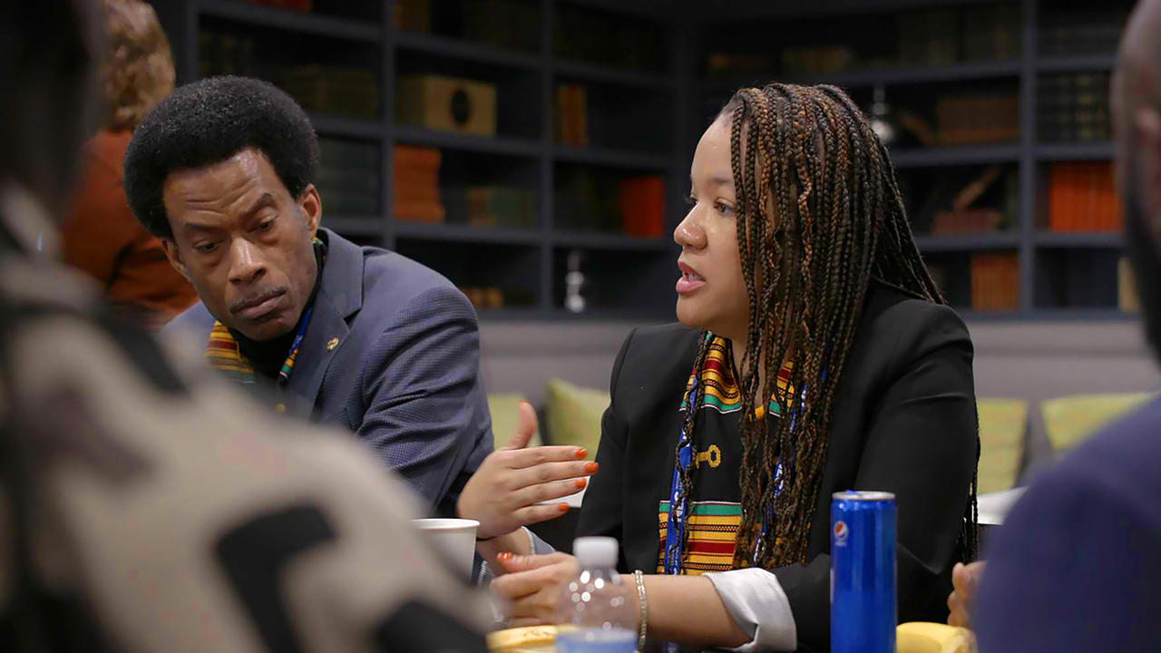 alderwoman Robin Rue Simmons talking at a table with others