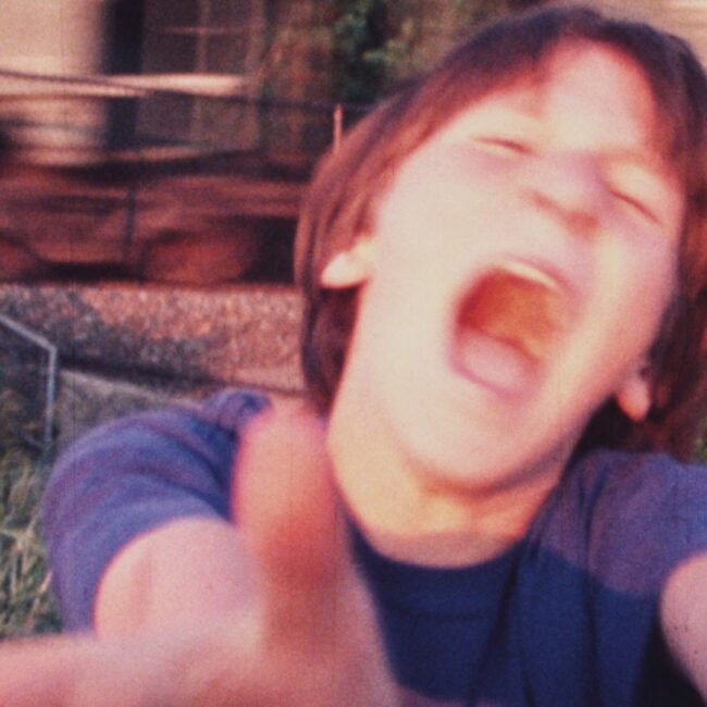 Sam Harkness, age 11, screams as a freight train passes by, Color Super-8mm, 1998