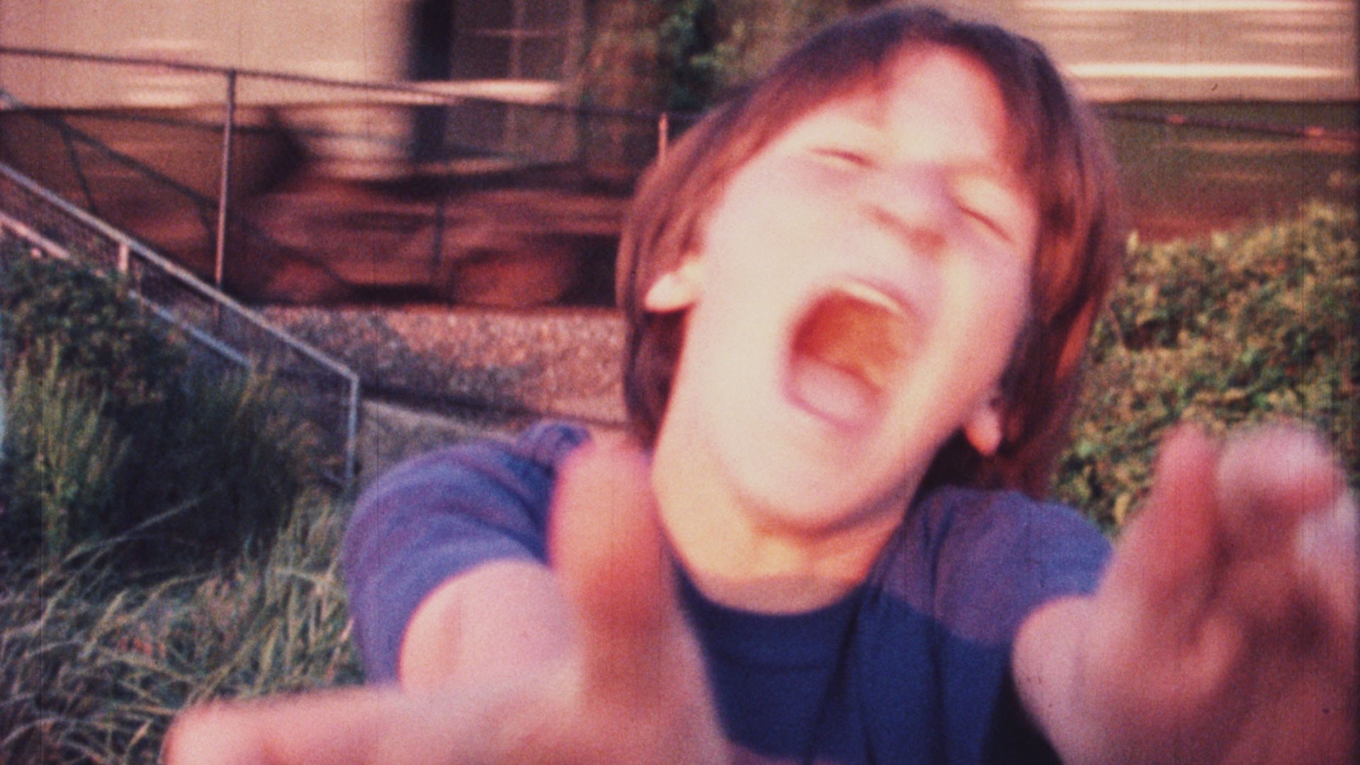 Sam Harkness, age 11, screams as a freight train passes by, Color Super-8mm, 1998