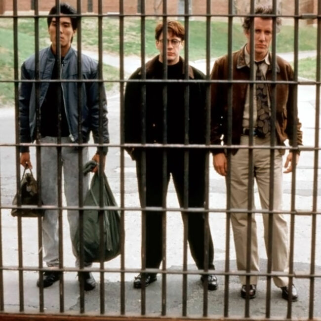 Yuji Okumoto as Shu Kai Kim, Robert Downey Jr. and James Woods standing in front of prison cell bars, in True Believer