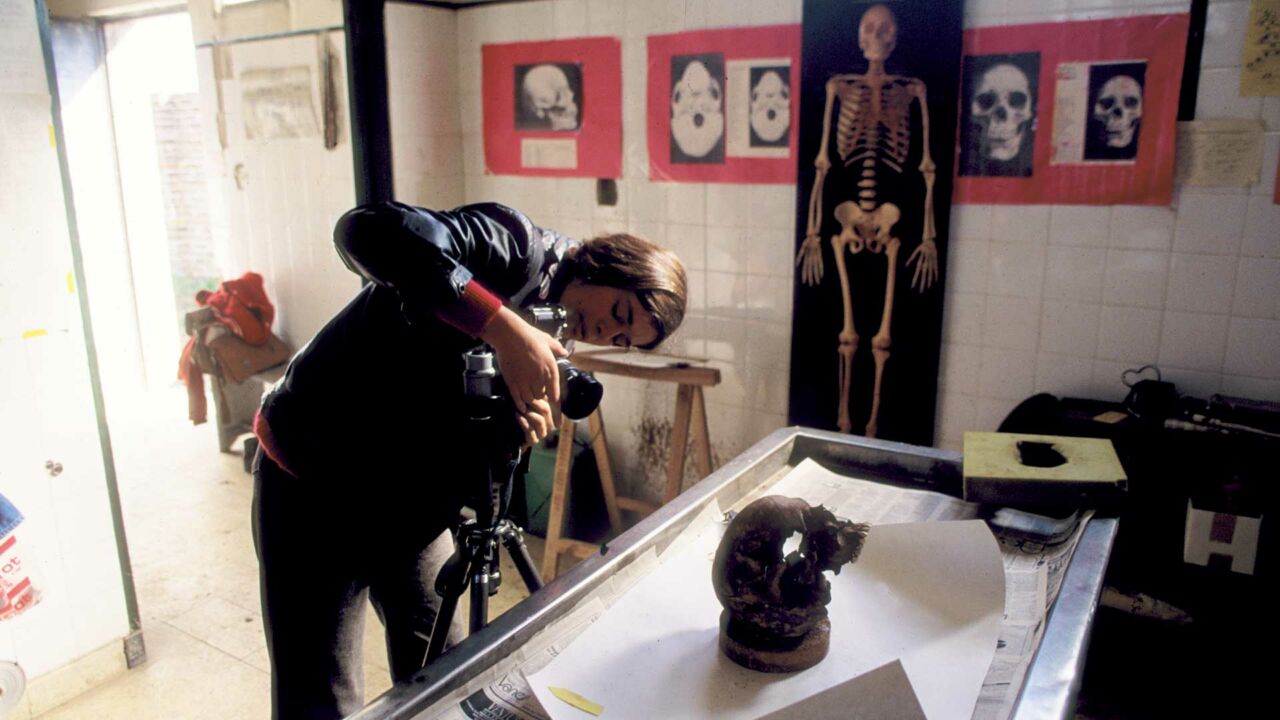 Mercedes "Mimi" Doretti photographs a skull in Buenos Aires, Argentina. Doretti would go on to co-found the Argentine Forensic Anthropology Team and would received a MacArthur "Genuis" grant for her work helping to identify missing and dissapeared persons.