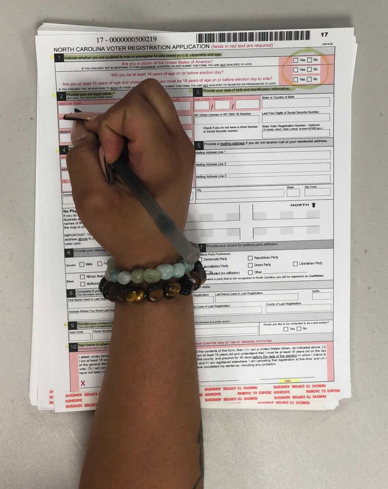 Voting rights organizations like You Can Vote highlight necessary parts of registration forms and absentee ballot requests to help incarcerated voters avoid errors that could lead to rejections. Photo by Hannah Critchfield Vote-Ground-Truth-N-Carolina-IMG_5085.jpg