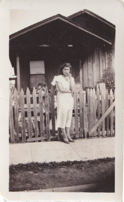 Soledad in front of the home into which her grandparents moved after the flood. Courtesy Gloria Velasco Flood-Soledad-single.jpg