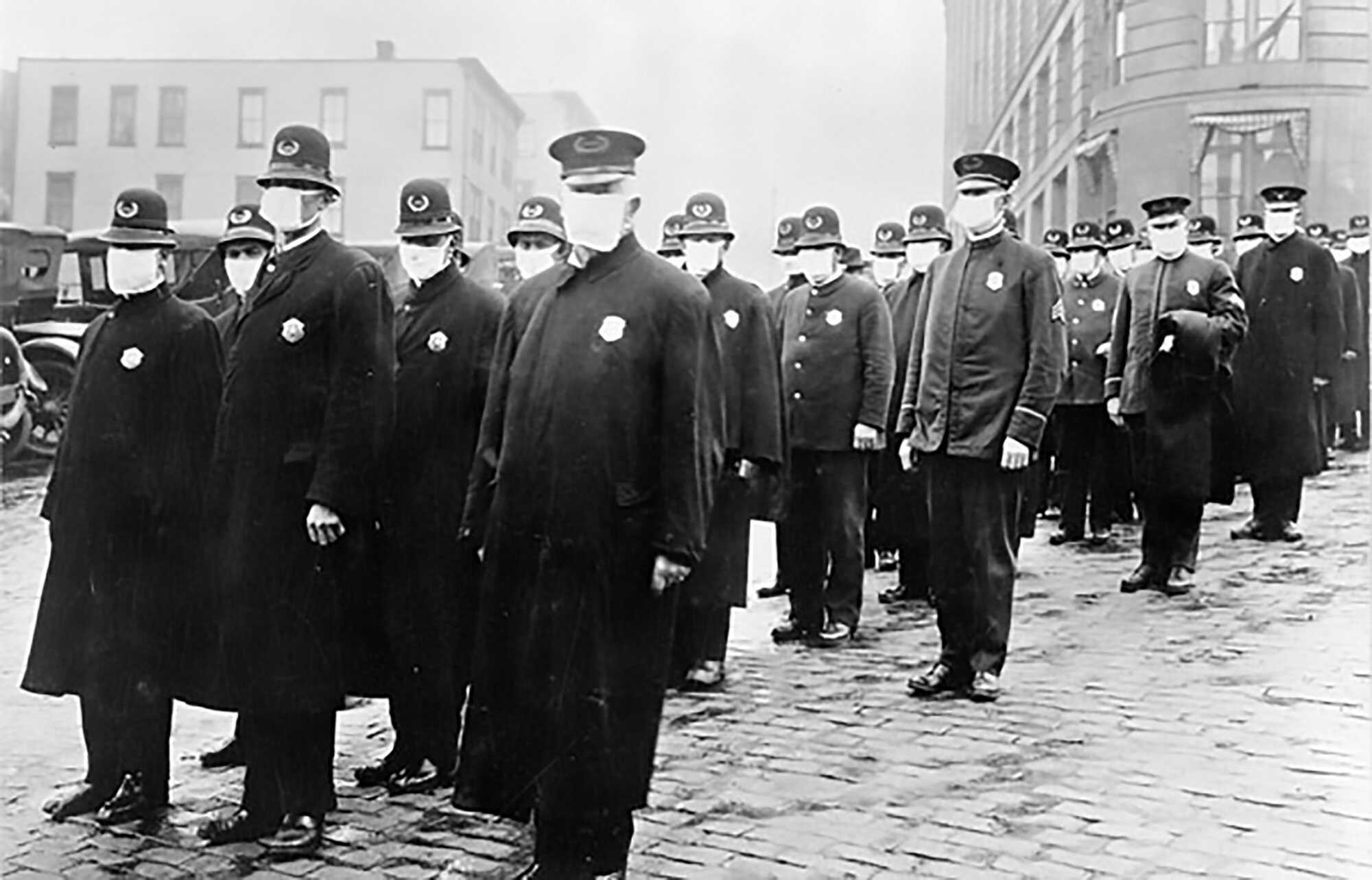 Police officers in Seattle wear masks while protecting the public. Courtesy: NARA Influenza-Blue-Seattle-Police-1918-NARA.jpg