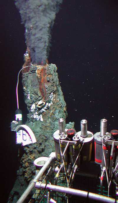 Black smoker hydrothermal chimney on the East Pacific Rise. A recording temperature probe hangs off it to the left and titanium fluid samplers can be seen in the lower right. (c) (c) Woods Hole Oceanographic Institution and the National Science Foundation Sealab-scientist-5.jpg